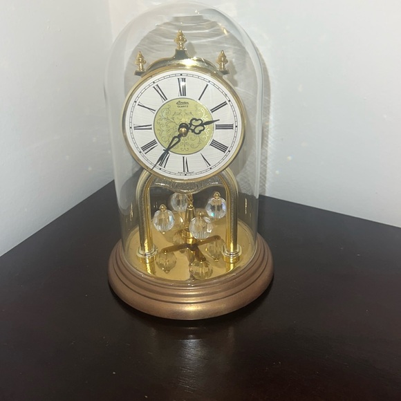 Linden Quartz clock. Gold with black hands, glass dome 10” tall 5” across - Picture 1 of 4